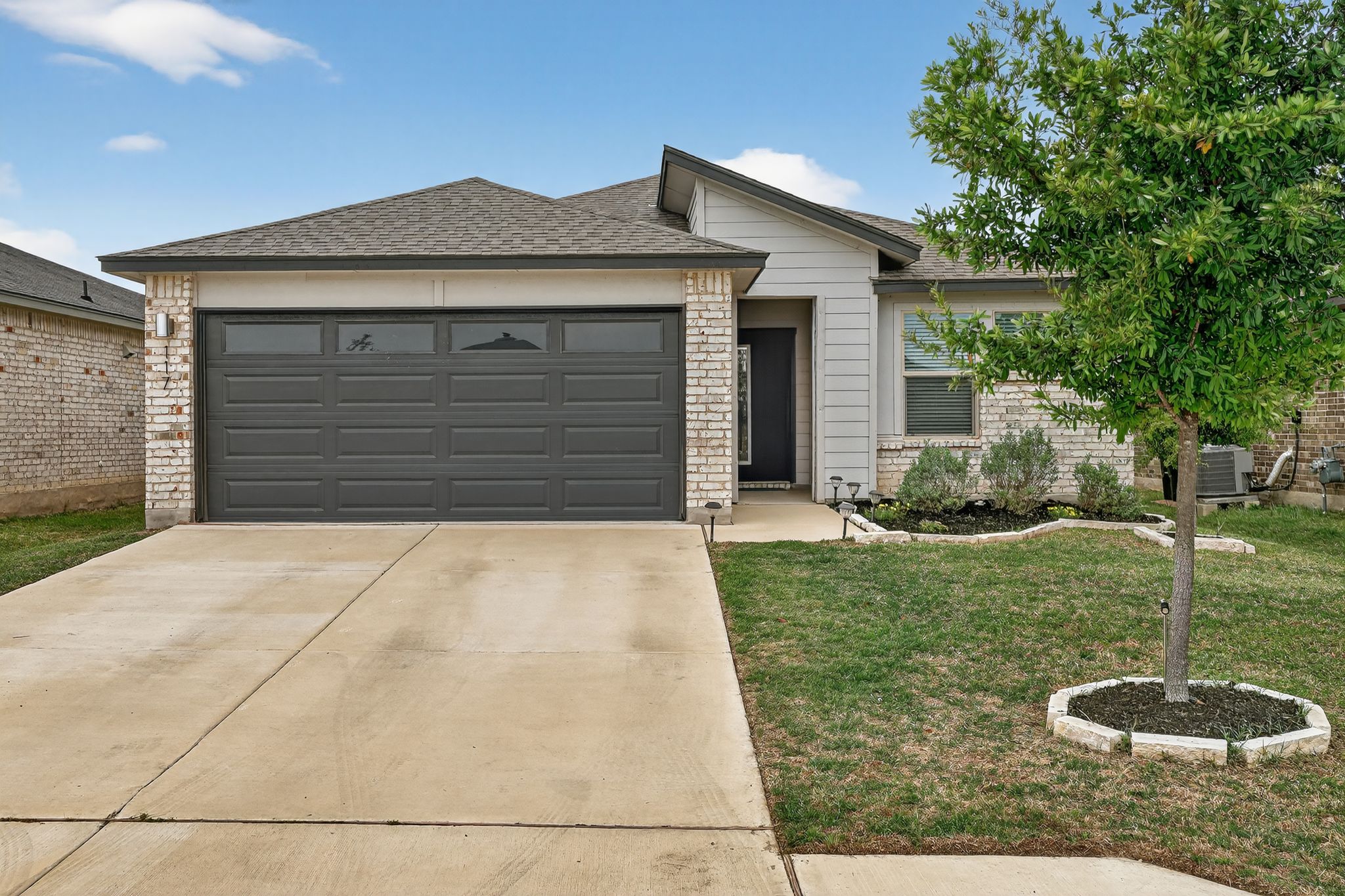 117 Halford Road Georgetown, TX 78633 - Photo 1 of 31 View of front of property featuring brick siding, concrete driveway, a front yard, a garage, and a shingled roof