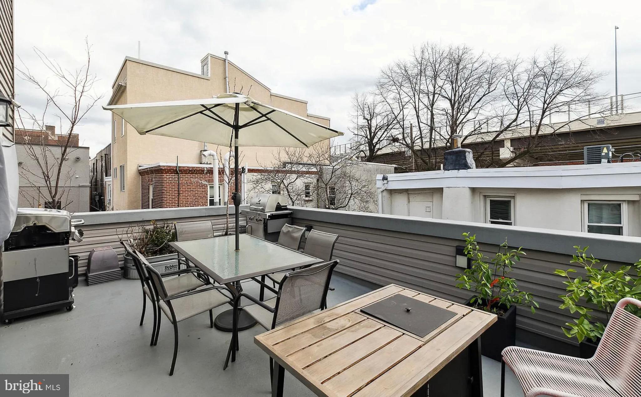 2813 Tilton Street Philadelphia, PA 19134 - Photo 11 of 33 a view of a patio with a table and chairs under an umbrella