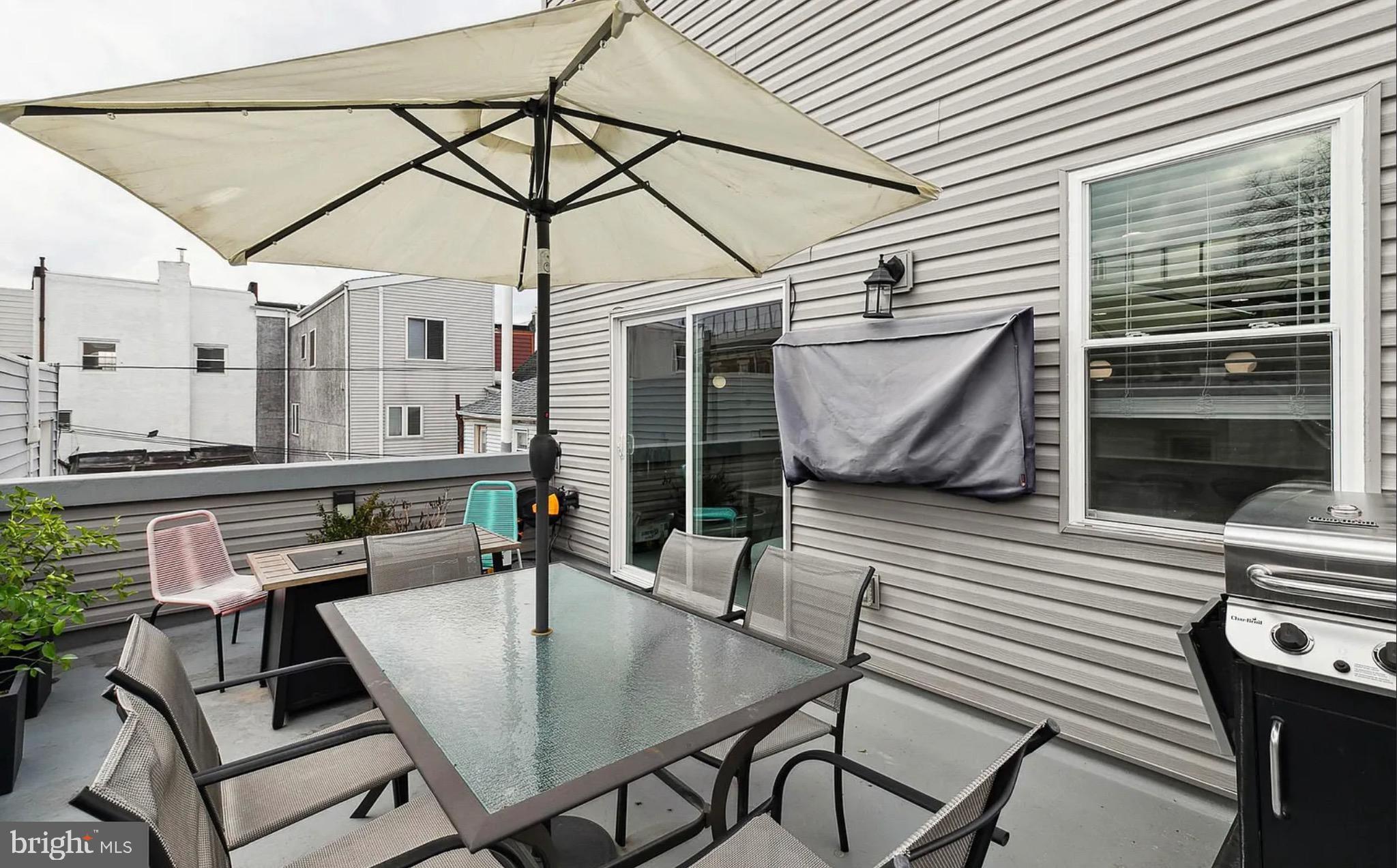 2813 Tilton Street Philadelphia, PA 19134 - Photo 12 of 33 a view of a patio with table and chairs with wooden floor and fence