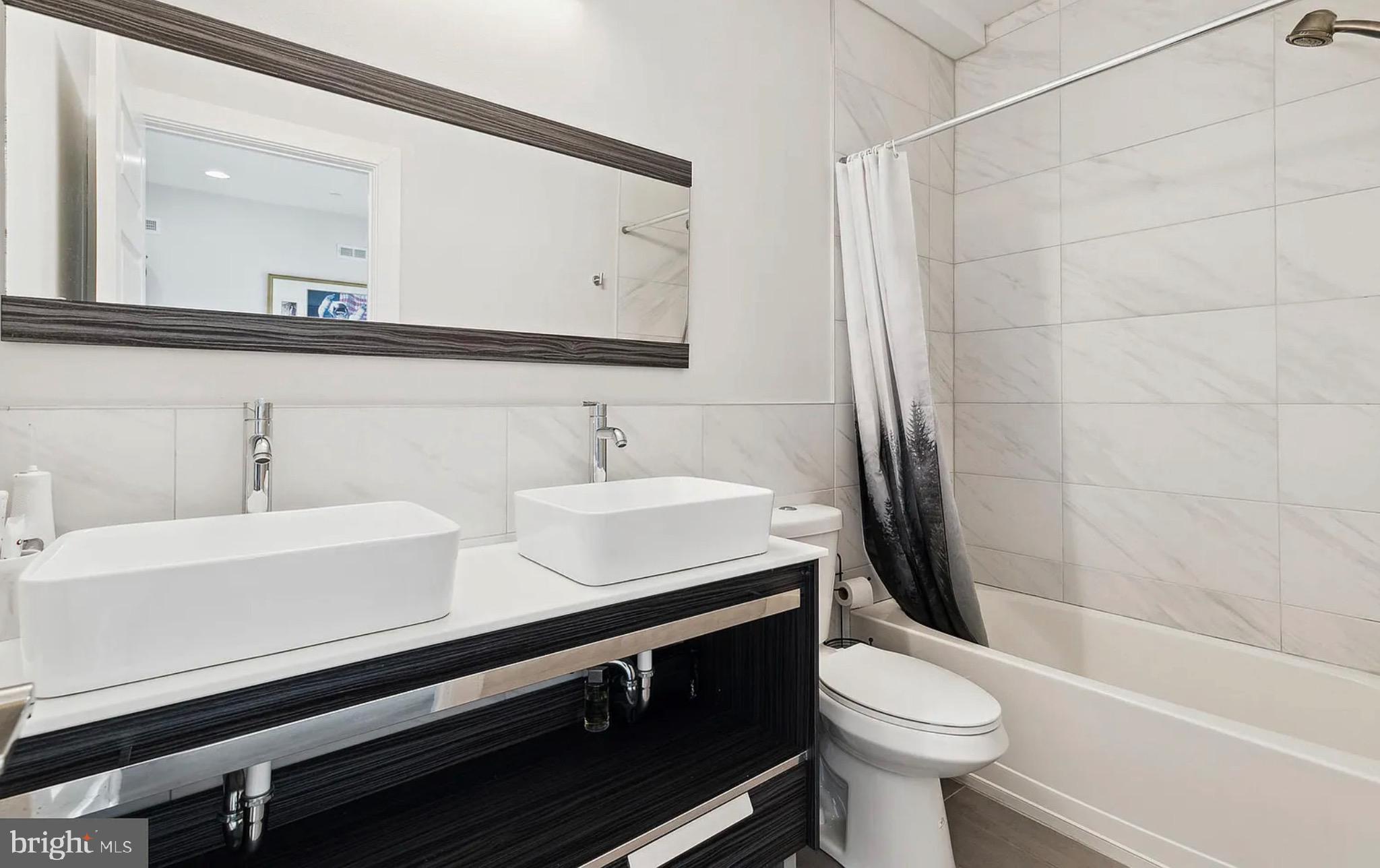 2813 Tilton Street Philadelphia, PA 19134 - Photo 15 of 33 a bathroom with a sink and a mirror