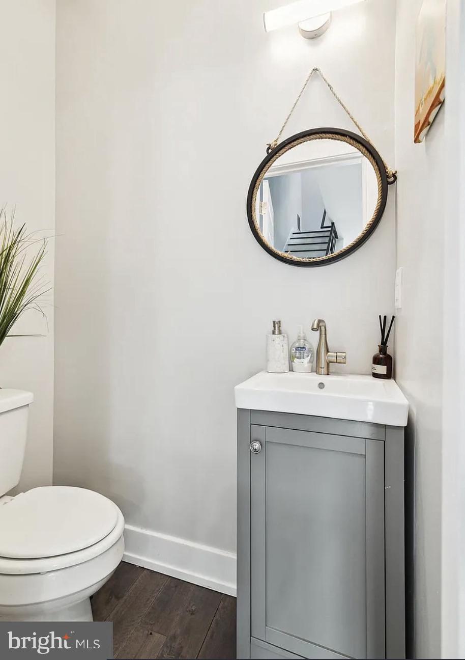 2813 Tilton Street Philadelphia, PA 19134 - Photo 16 of 33 a bathroom with a sink a toilet and a mirror