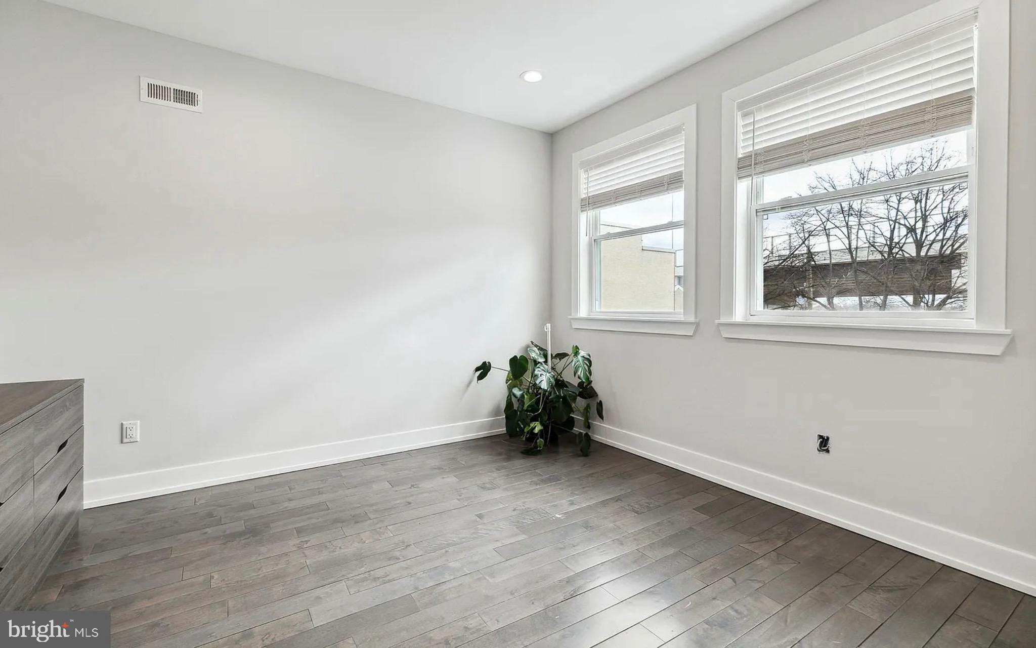 2813 Tilton Street Philadelphia, PA 19134 - Photo 17 of 33 an empty room with wooden floor and windows