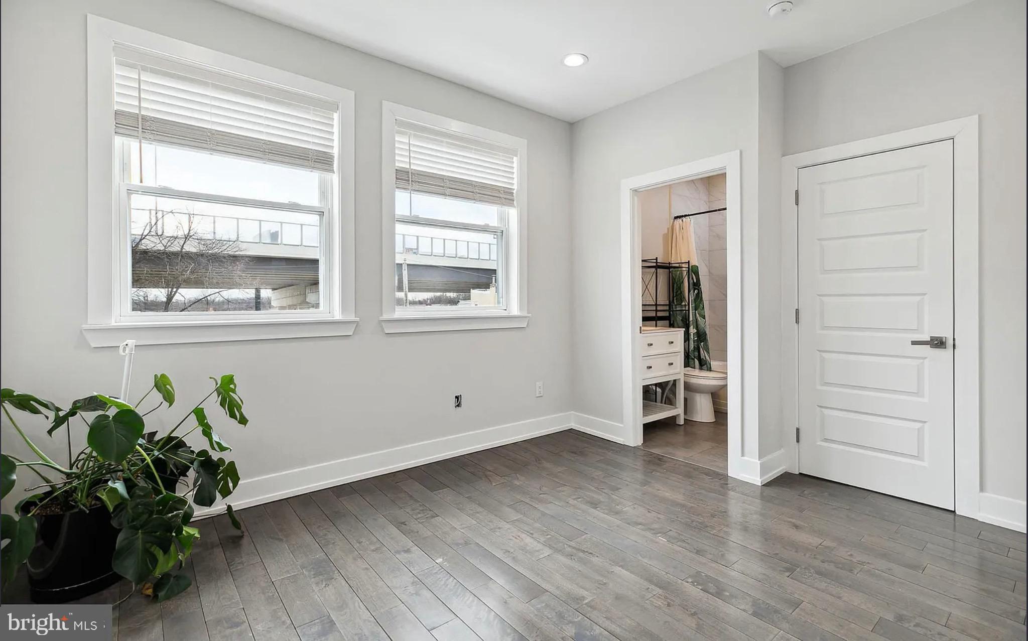 2813 Tilton Street Philadelphia, PA 19134 - Photo 19 of 33 an empty room with wooden floor and windows