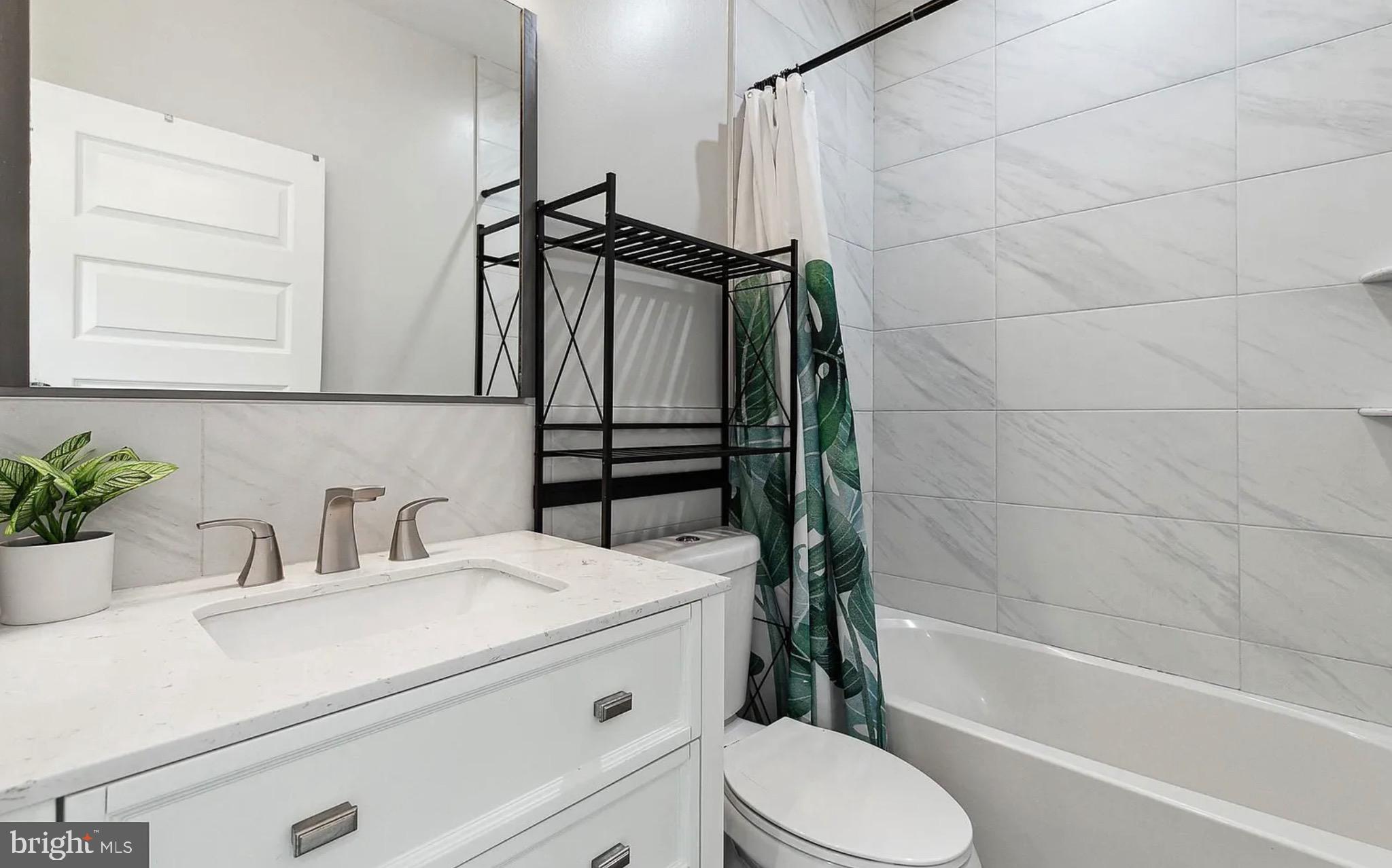 2813 Tilton Street Philadelphia, PA 19134 - Photo 20 of 33 a bathroom with a sink toilet and shower