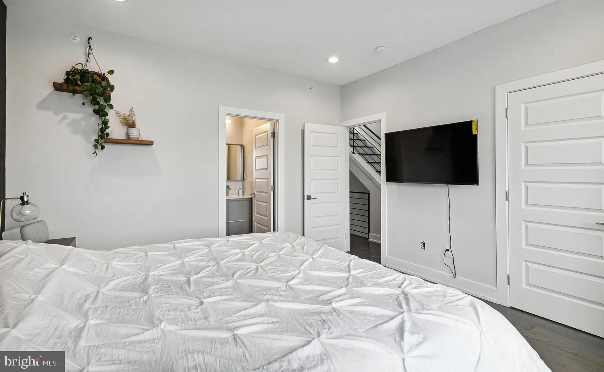 2813 Tilton Street Philadelphia, PA 19134 - Photo 23 of 33 a bedroom with a bed and a flat screen tv