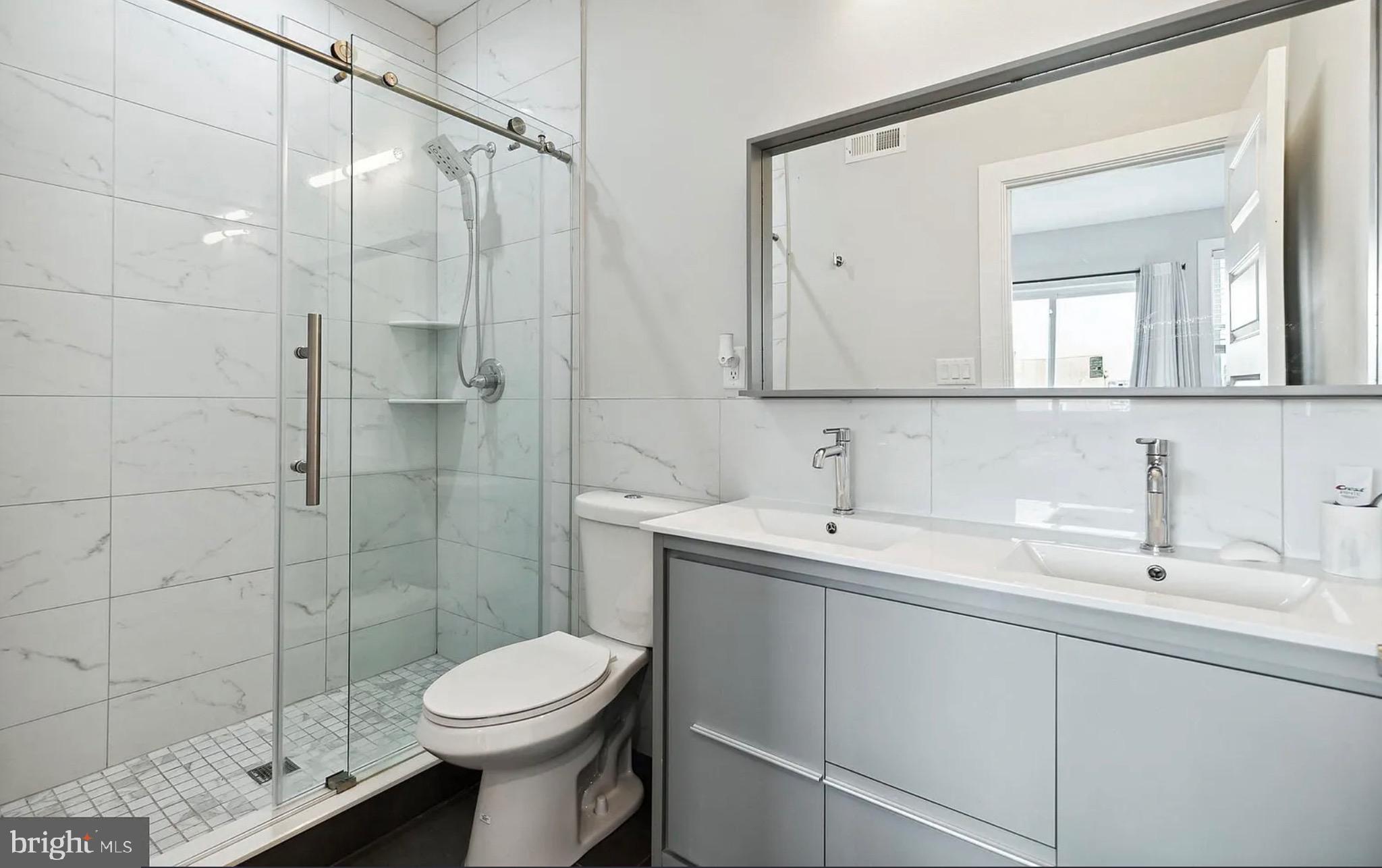 2813 Tilton Street Philadelphia, PA 19134 - Photo 25 of 33 a bathroom with a sink toilet and shower