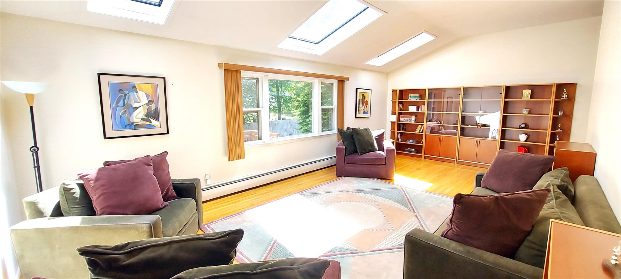 a living room with furniture and floor to ceiling windows