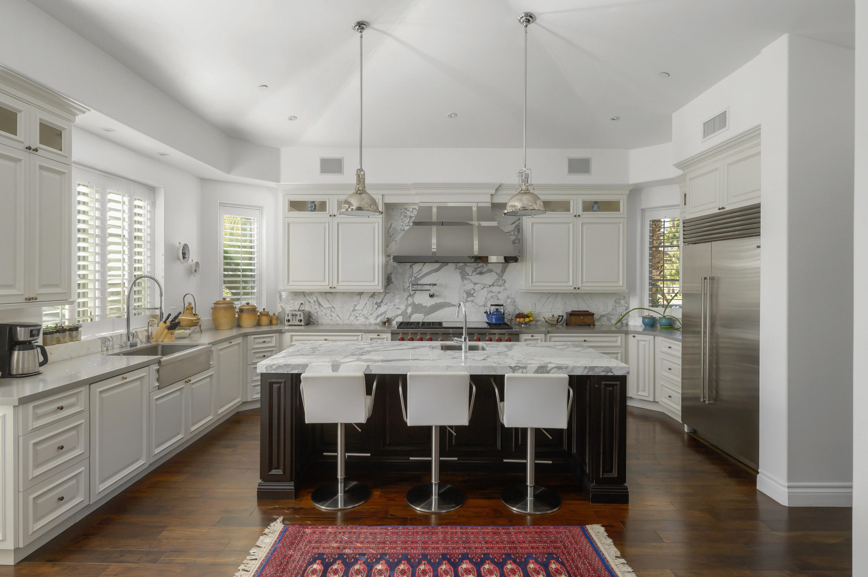 82425 Ave 55 Thermal, CA 92274 - Photo 11 of 46 a kitchen with a table chairs sink and cabinets
