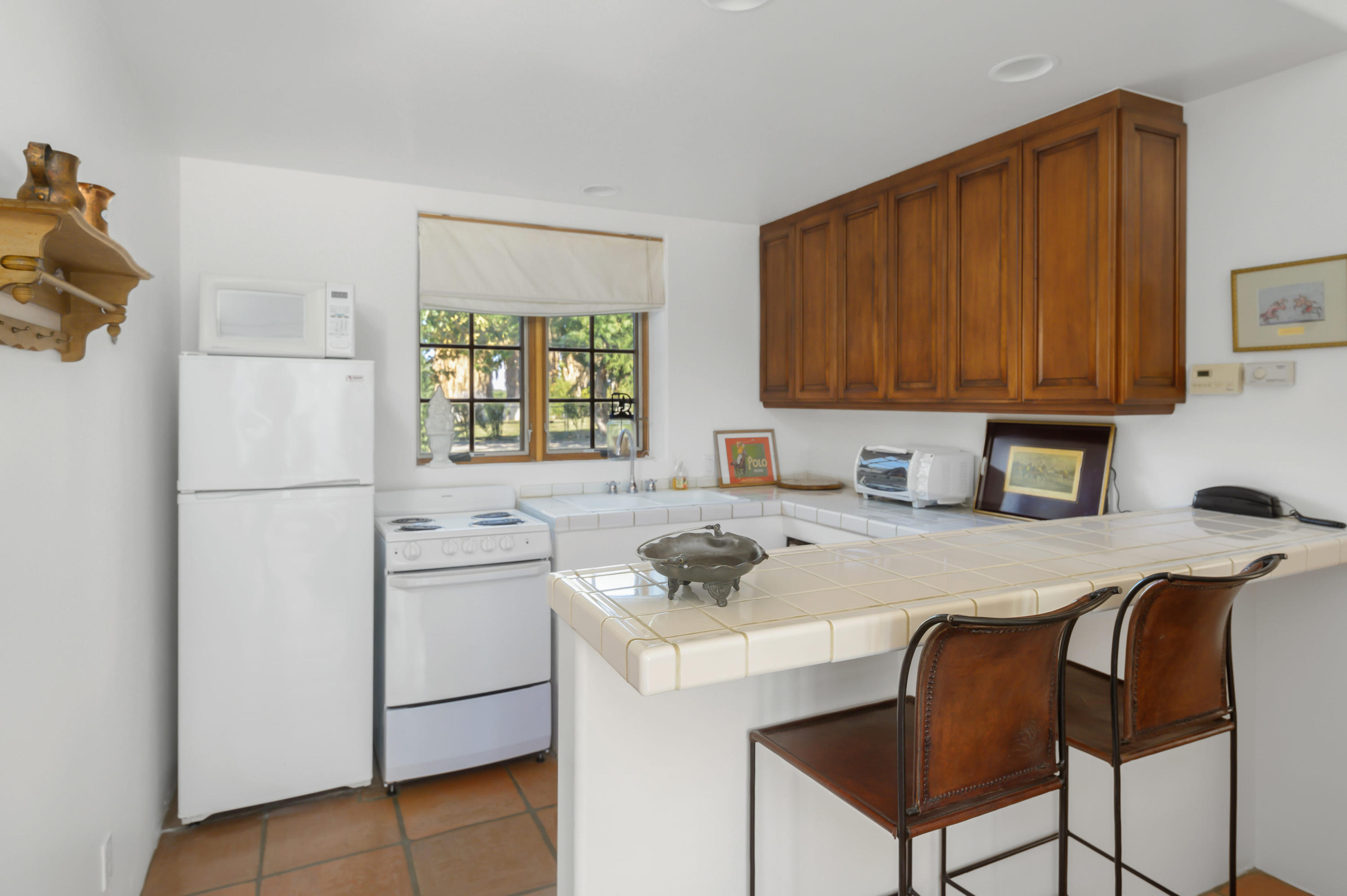 82425 Ave 55 Thermal, CA 92274 - Photo 40 of 46 a kitchen with a stove a refrigerator and cabinets