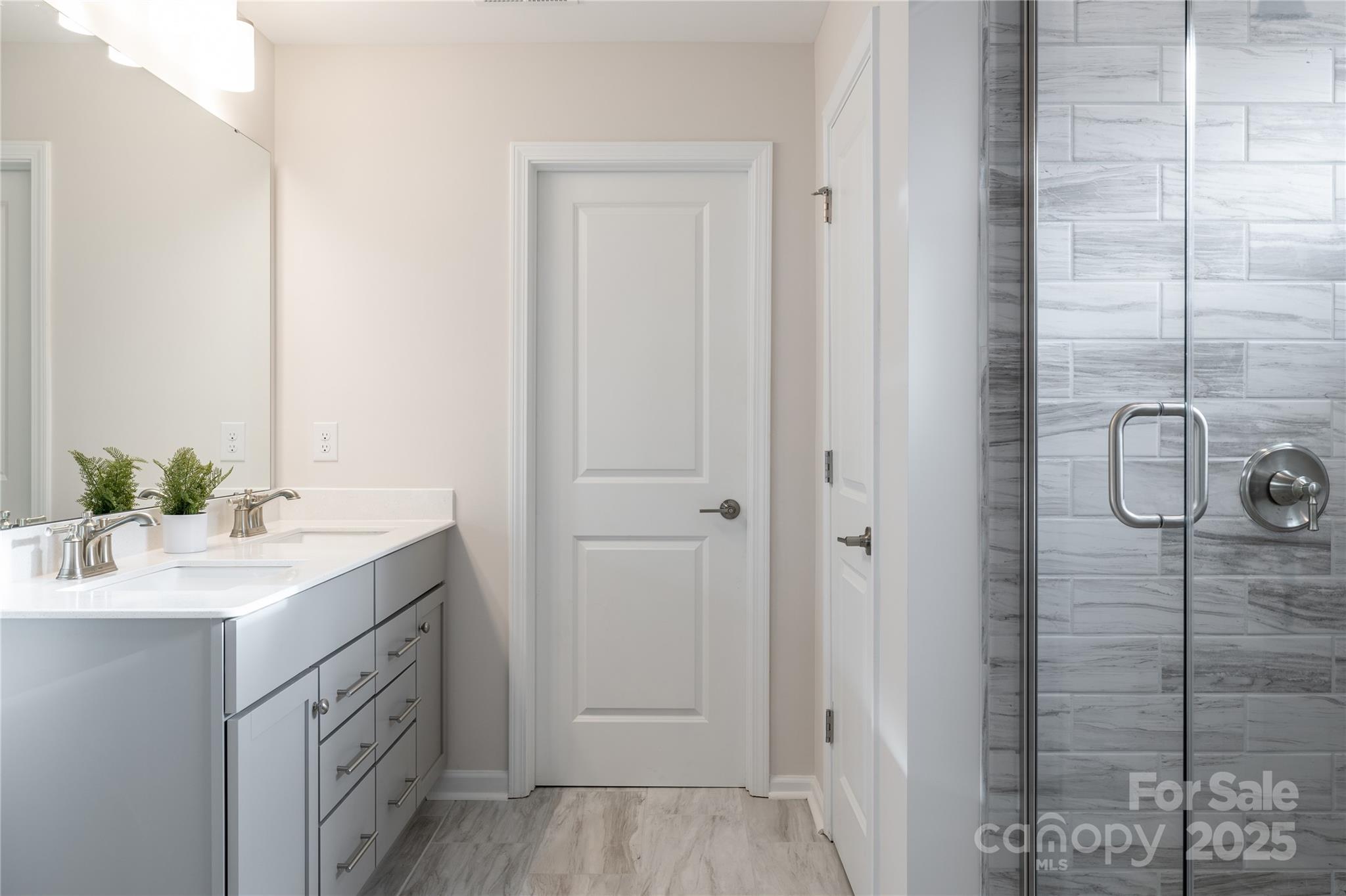 5819 Stewarts Lndg Road, Unit 65 Charlotte, NC 28215 - Photo 2 of 8 a bathroom with a double vanity sink and mirror