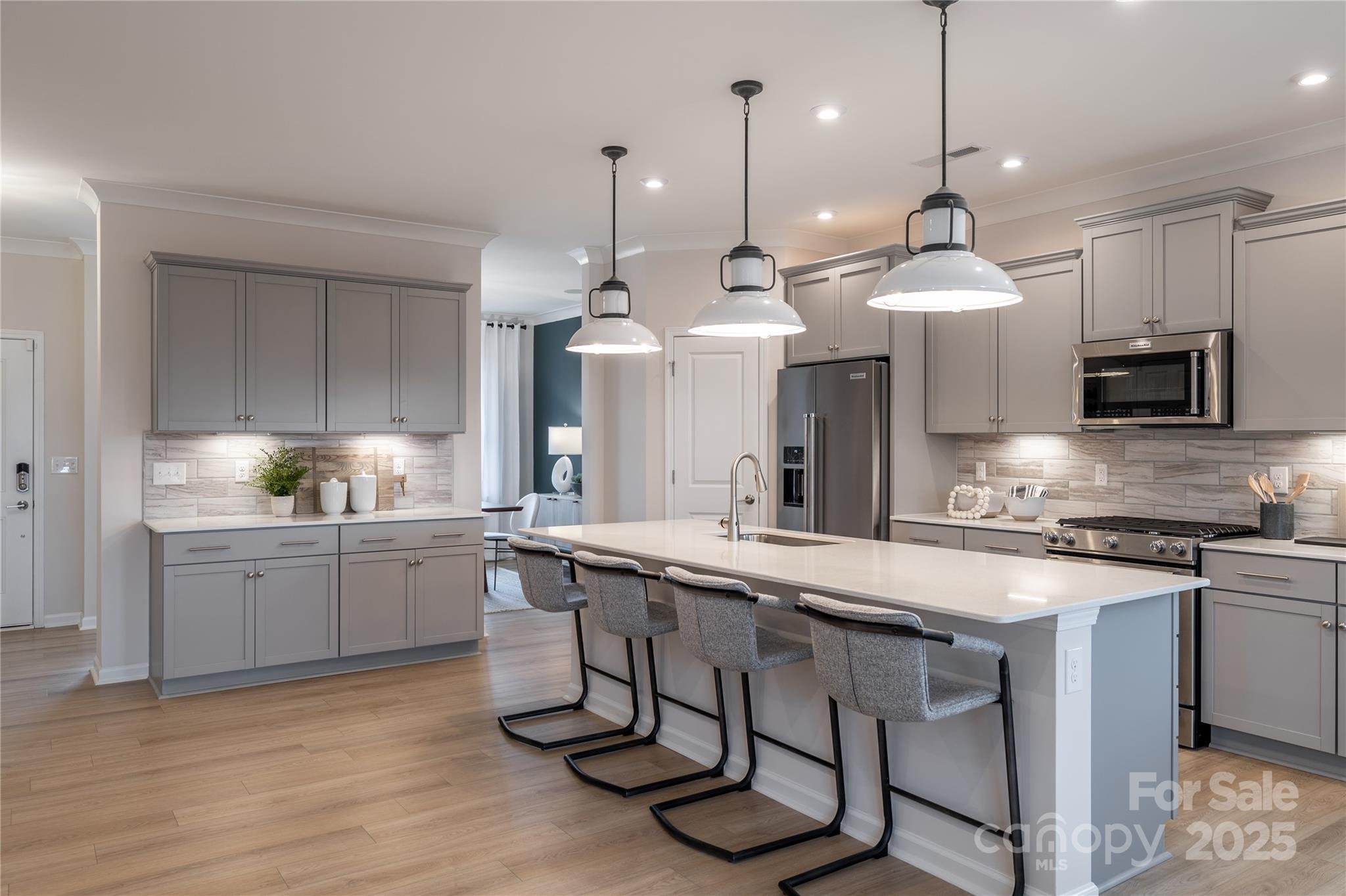 5819 Stewarts Lndg Road, Unit 65 Charlotte, NC 28215 - Photo 4 of 8 a kitchen with stainless steel appliances granite countertop a sink a stove a refrigerator and island