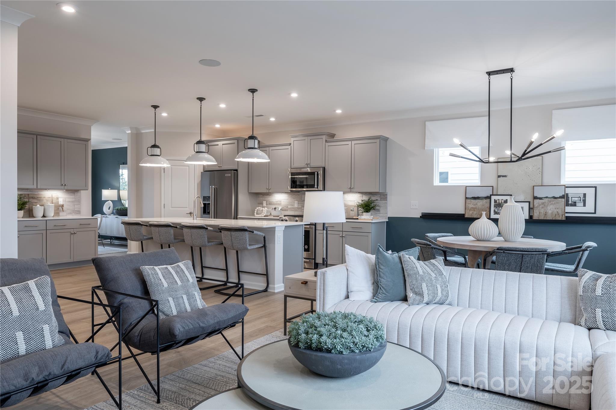 5819 Stewarts Lndg Road, Unit 65 Charlotte, NC 28215 - Photo 6 of 8 a living room with kitchen kitchen furniture and a chandelier