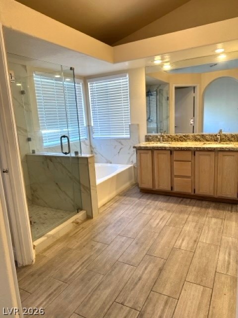 2152 Falcon Pointe Lane Henderson, NV 89074 - Photo 4 of 11 Full bathroom featuring a marble finish shower, double vanity, a garden tub, lofted ceiling, and wood finish floors