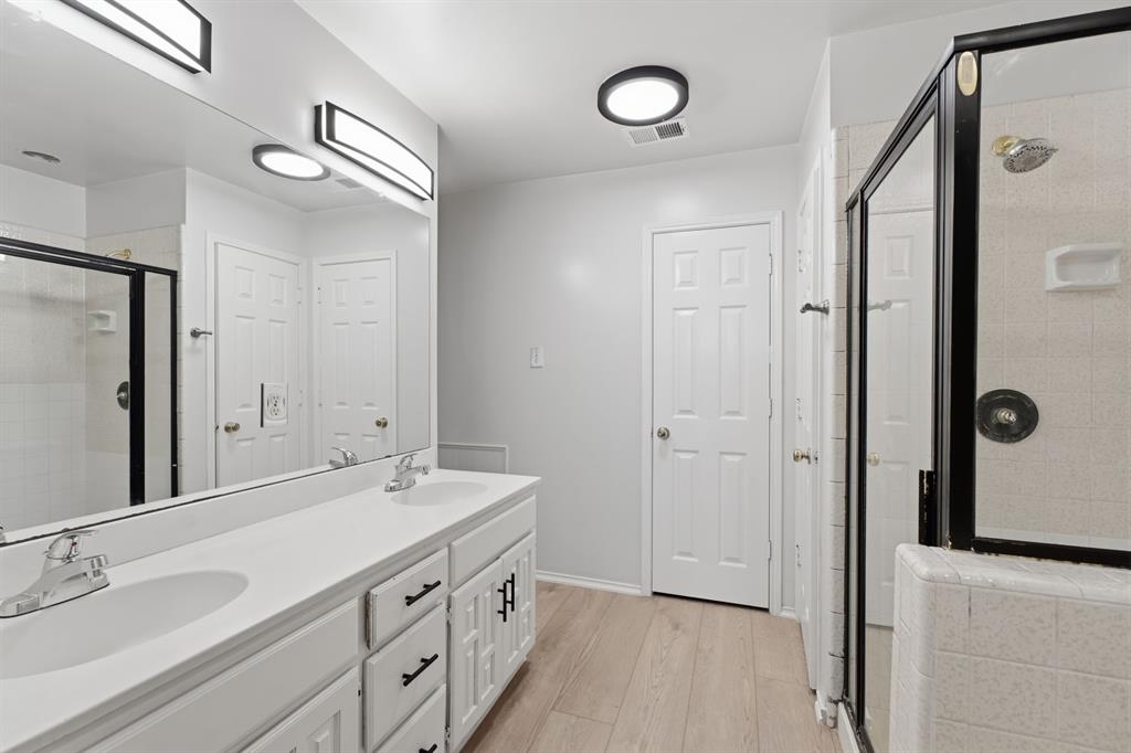 3721 Smartt Street Rowlett, TX 75088 - Photo 7 of 27 a spacious bathroom with a double vanity sink a mirror and a shower