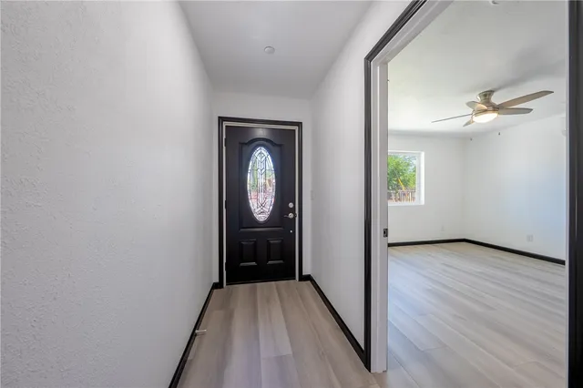 a view of a hallway with wooden floor