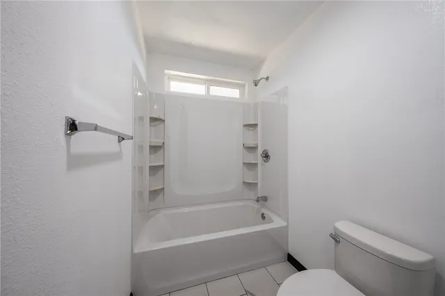 a bathroom with a toilet and a bathtub