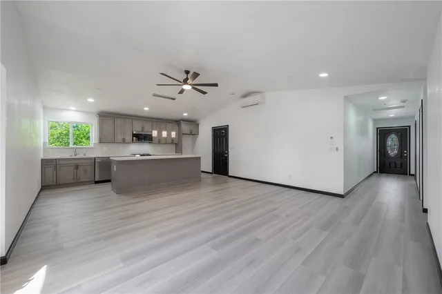 a view of a kitchen with a sink and a large window