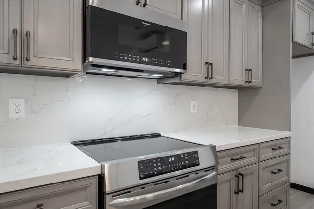 a stove top oven sitting inside of a kitchen