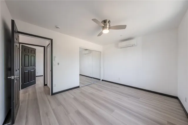 a view of a livingroom with a hardwood floor and a ceiling fan