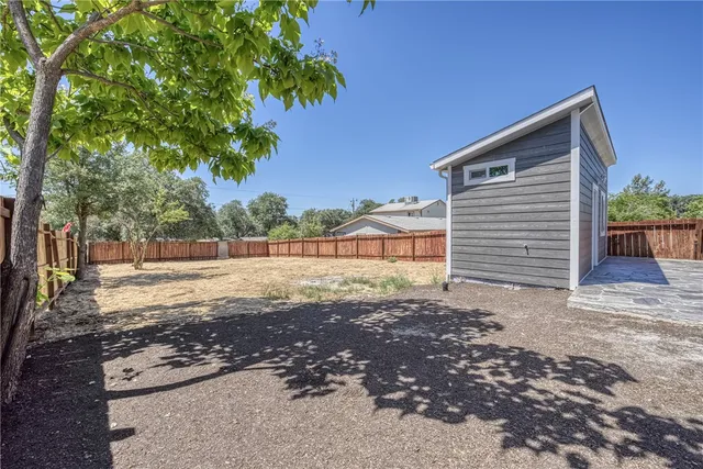 a view of backyard of house with green space