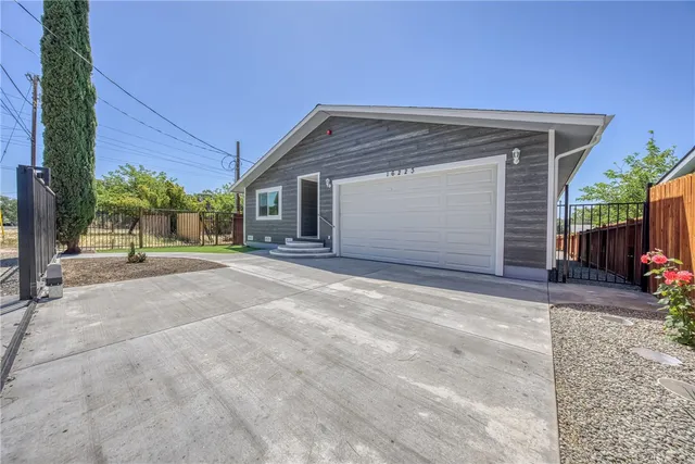 a view of a house with a backyard and garage