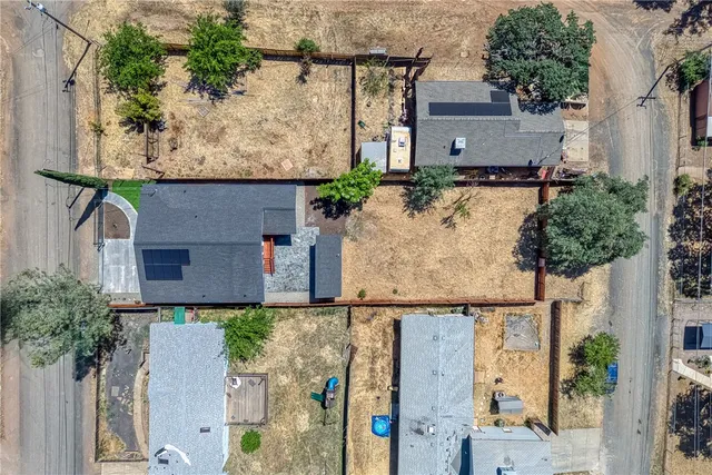 aerial view of a house with street sign and a small yard