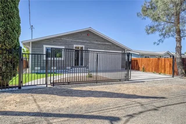 a view of a house with a backyard and a garage
