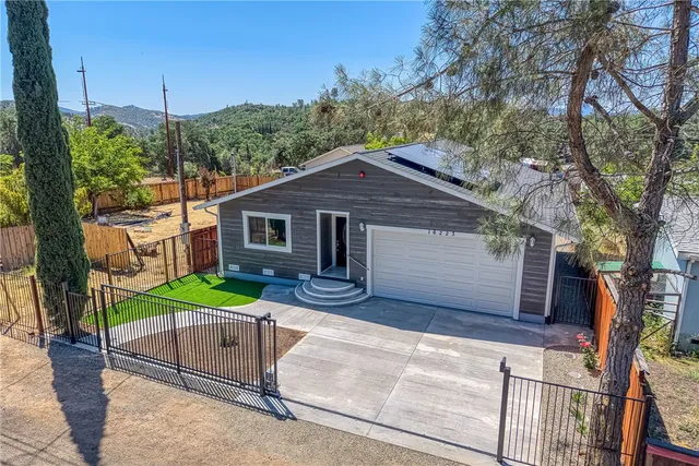 a house that has a tree in front of it
