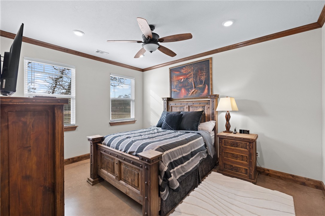 7440 Fm 39 Road South North Zulch, TX 77872 - Photo 34 of 50 a bedroom with a bed and a chandelier