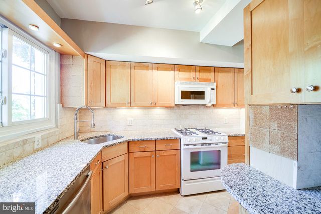 a view of a big room with stairs and a bed