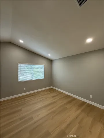 an empty room with wooden floor and closet
