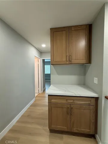 a view of kitchen with granite countertop cabinets