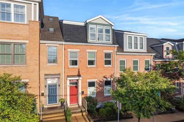 a front view of a building with a yard