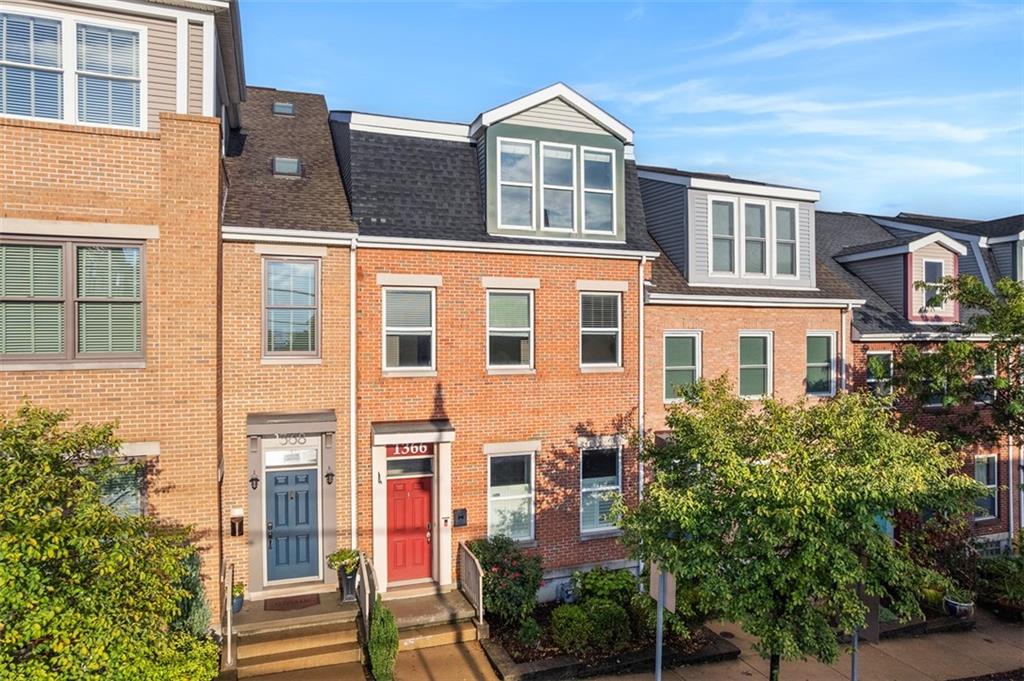 a front view of a building with a yard