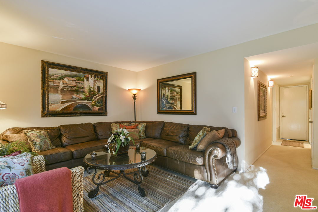 4875 Patrae Street Los Angeles, CA 90066 - Photo 11 of 23 a living room with furniture a couch and paintings on the wall
