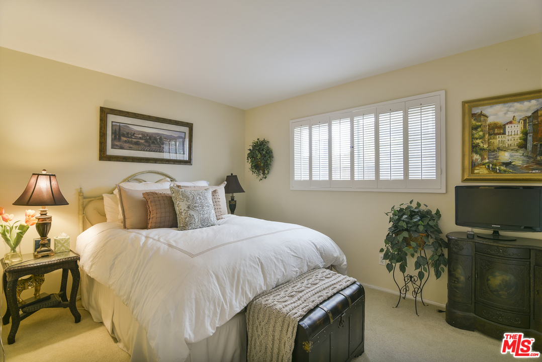 4875 Patrae Street Los Angeles, CA 90066 - Photo 12 of 23 a bedroom with a bed and a flat screen tv