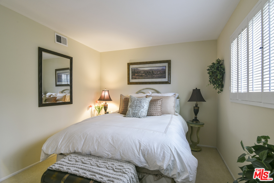 4875 Patrae Street Los Angeles, CA 90066 - Photo 13 of 23 a bedroom with a bed and a painting on the wall