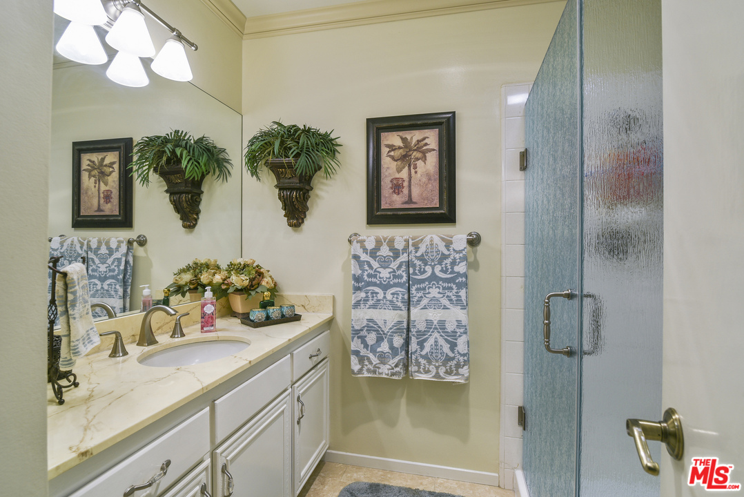 4875 Patrae Street Los Angeles, CA 90066 - Photo 14 of 23 a bathroom with a sink a mirror and a shower