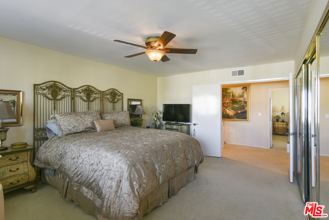 4875 Patrae Street Los Angeles, CA 90066 - Photo 15 of 23 a bedroom with a large bed and a chandelier