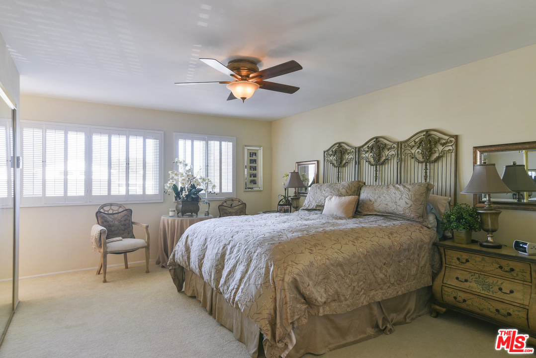 4875 Patrae Street Los Angeles, CA 90066 - Photo 16 of 23 a bedroom with a bed and a chandelier