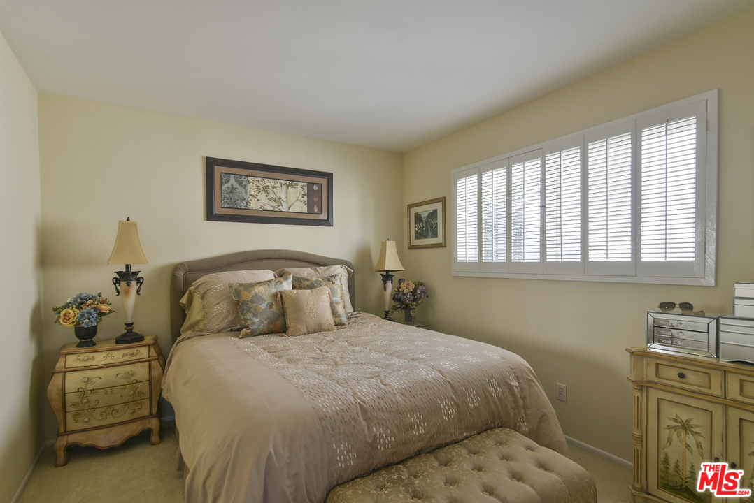 4875 Patrae Street Los Angeles, CA 90066 - Photo 19 of 23 a bedroom with a bed and wooden floor