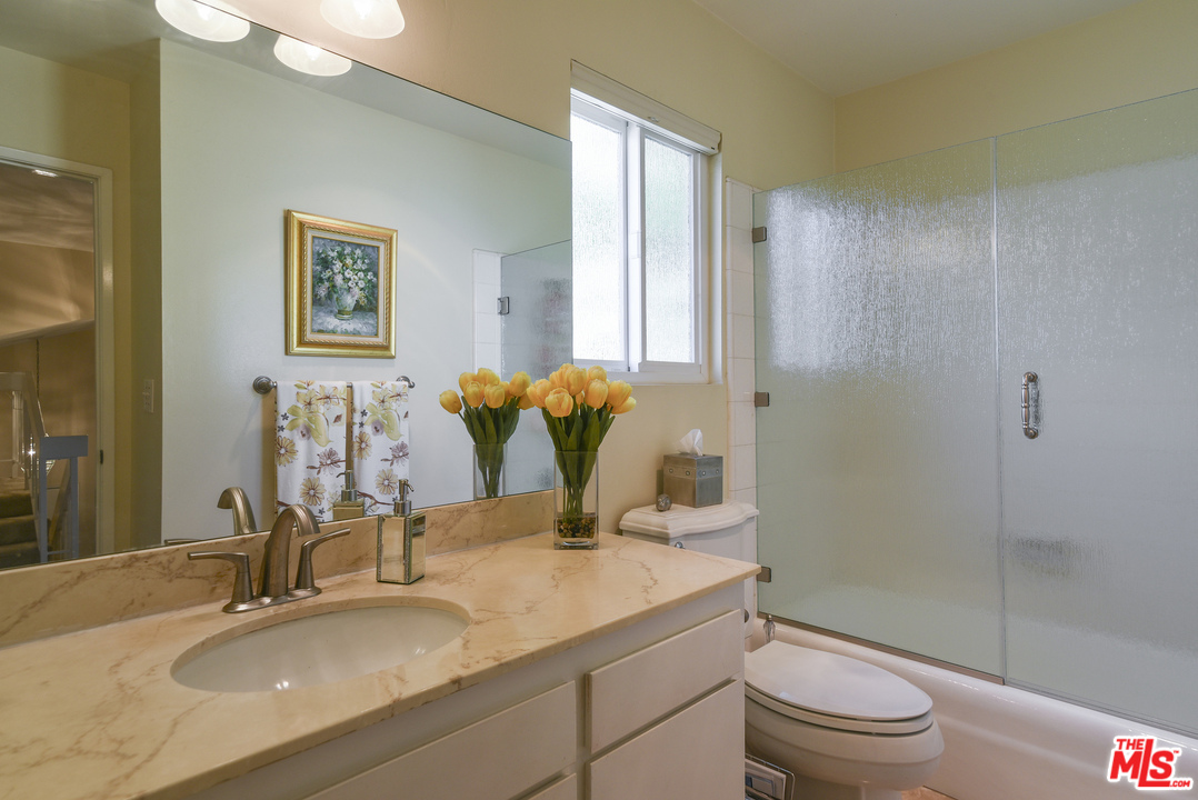 4875 Patrae Street Los Angeles, CA 90066 - Photo 20 of 23 a bathroom with a granite countertop sink a toilet and shower