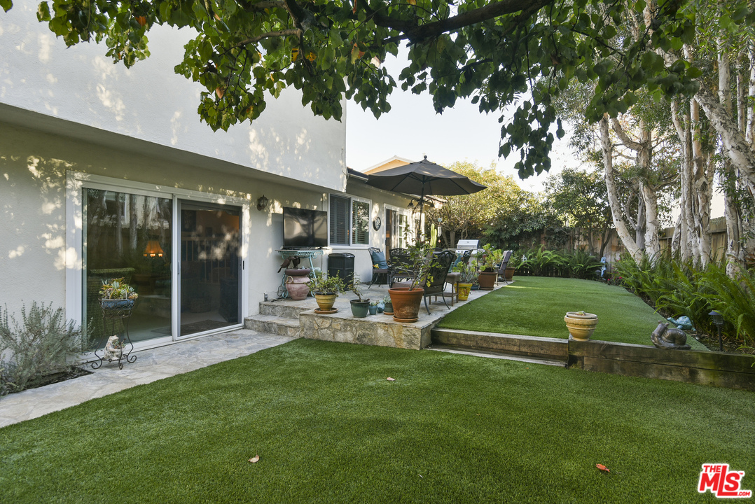 4875 Patrae Street Los Angeles, CA 90066 - Photo 22 of 23 a view of a patio with a table and chairs under an umbrella