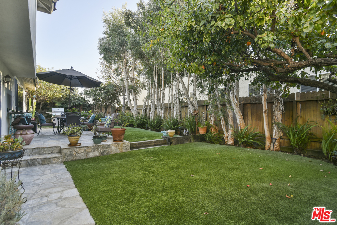 4875 Patrae Street Los Angeles, CA 90066 - Photo 23 of 23 a view of a patio with a table and chairs under an umbrella