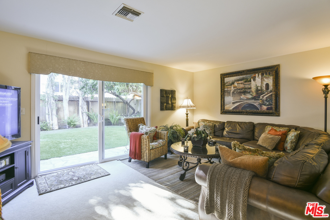 4875 Patrae Street Los Angeles, CA 90066 - Photo 10 of 23 a living room with furniture and a floor to ceiling window