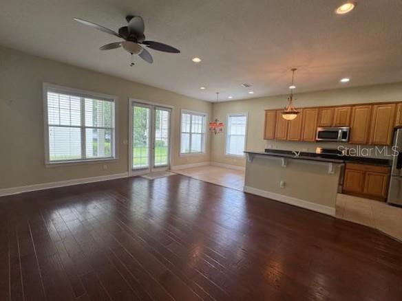 1442 Stickley Avenue Celebration, FL 34747 - Photo 11 of 46 a large kitchen with stainless steel appliances granite countertop a stove top oven a sink dishwasher and a oven with wooden floor