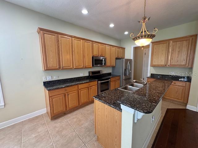 1442 Stickley Avenue Celebration, FL 34747 - Photo 13 of 46 a kitchen with stainless steel appliances granite countertop a sink stove and refrigerator
