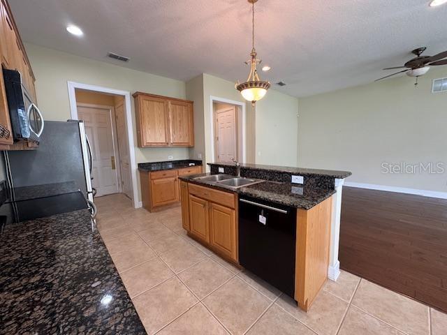 1442 Stickley Avenue Celebration, FL 34747 - Photo 14 of 46 a kitchen with stainless steel appliances granite countertop a sink and a refrigerator
