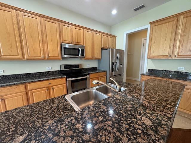 1442 Stickley Avenue Celebration, FL 34747 - Photo 15 of 46 a kitchen with stainless steel appliances granite countertop a refrigerator sink and cabinets