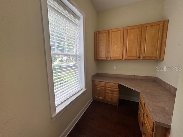 1442 Stickley Avenue Celebration, FL 34747 - Photo 17 of 46 a kitchen with granite countertop white cabinets and a window